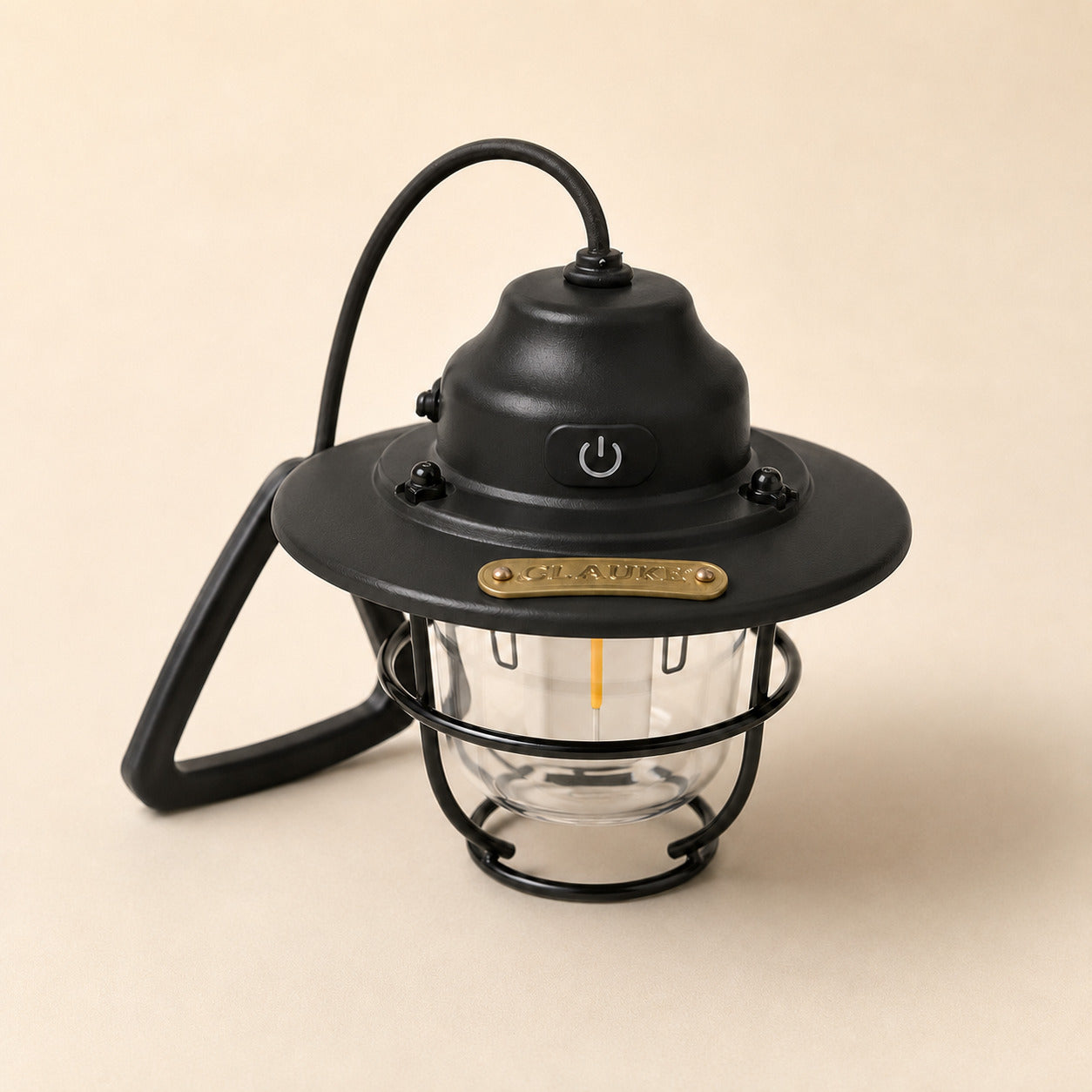 A black lantern-style outdoor light with a clear glass shade, black metal cage, curved hanging cord, and a small gold-toned brand plaque reading 'OLIVIER'.